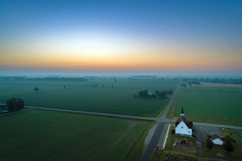 rural church near a crossroad and hazy sky