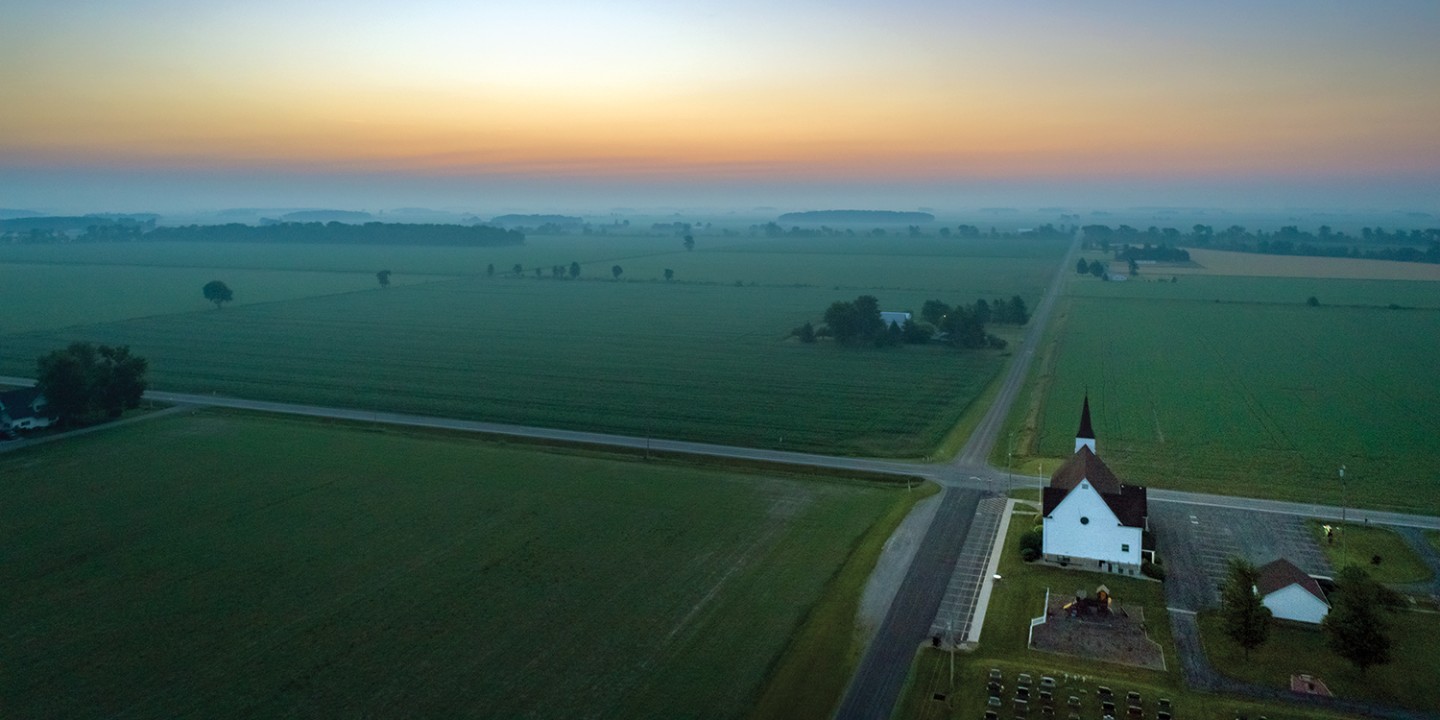 rural church near a crossroad and hazy sky